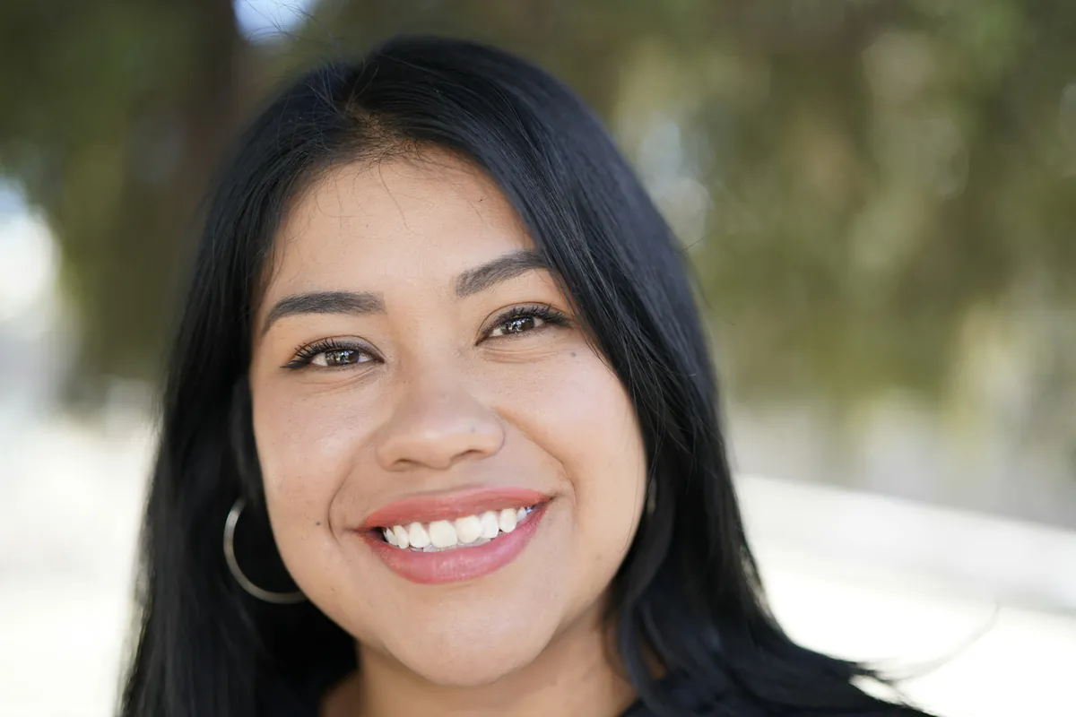 A smiling program director outdoors