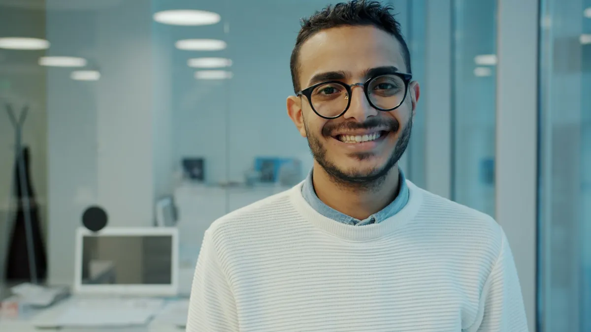 A smiling business owner in a bright office