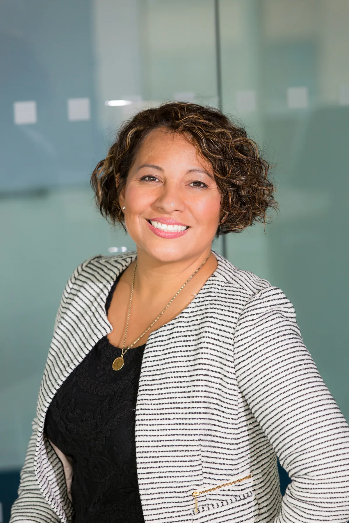 A smiling office manager in a tweed jacket